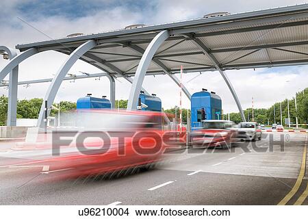 Picture - Car travelling through toll booth at bridge. Fotosearch