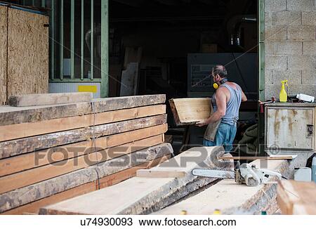 Carpenter working in workshop View Large Photo Image Stock Image - Carpenter working in workshop. Fotosearch