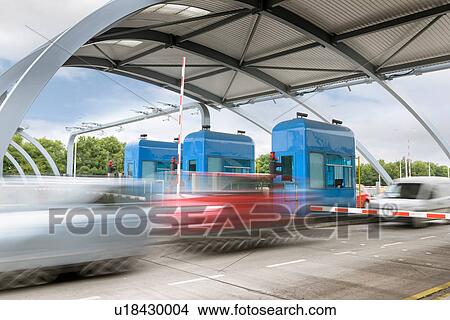 Picture - Cars travelling through toll booth at bridge. Fotosearch