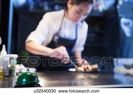 Chef in commercial kitchen preparing food View Large Photo Image Stock Image - Chef in commercial kitchen preparing food. Fotosearch