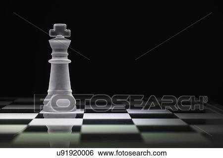 Stock Photograph - Chess king on chess board. Fotosearch