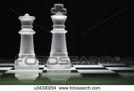 Chess queen and king on chess board View Large Photo Image Picture - Chess queen and king on chess board. Fotosearch