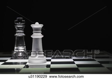 Chess queen and king on chess board View Large Photo Image Stock Photo - Chess queen and king on chess board. Fotosearch