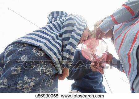Children looking in fishing net View Large Photo Image Stock Photography - Children looking in fishing net. Fotosearch