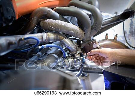 Stock Image - Close up of exhaust valve actuator on engine in research and development facility of factory. Fotosearch