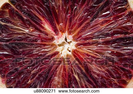 Stock Image - Close up of half of red orange. Fotosearch