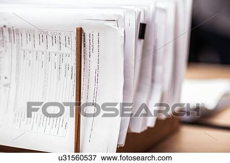 Close up of ordered paperwork in office desk rack View Large Photo Image Stock Photo - Close up of ordered paperwork in office desk rack. Fotosearch