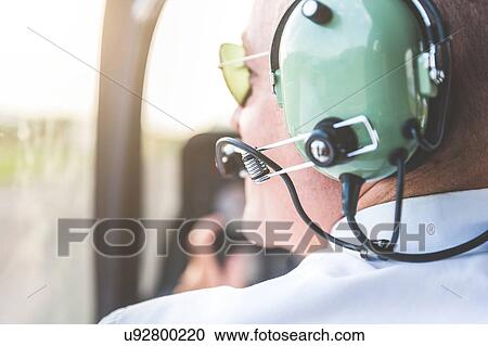 Stock Image - Close up of pilot in cockpit of aircraft. Fotosearch