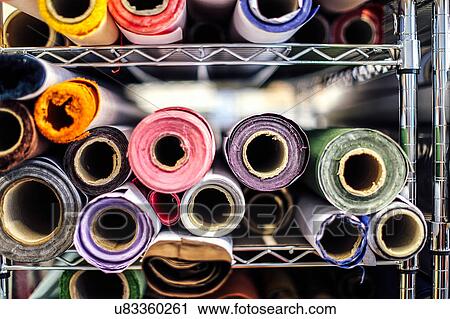 Stock Image - Close-up of rolls of cloth in book arts workshop. Fotosearch