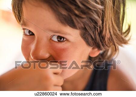 Picture - Close up portrait of boy looking at camera. Fotosearch