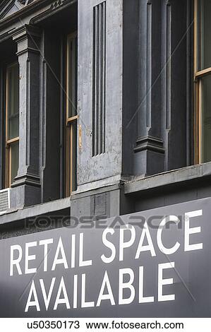 Stock Image - Close-up view of building facade with rental sign. Fotosearch