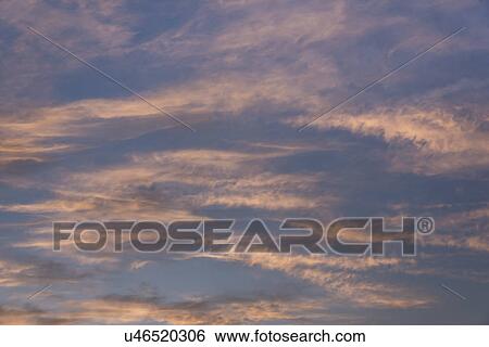 Stock Photograph - Cloudscape at sunset. Fotosearch