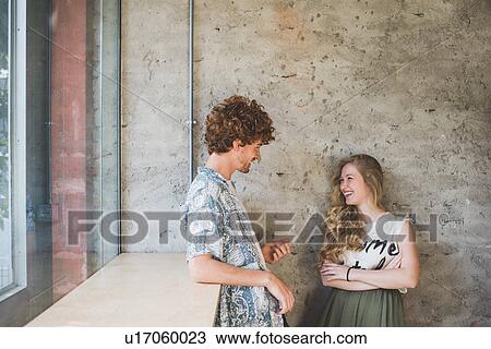Stock Image - Co-workers beside bar counter by window. Fotosearch