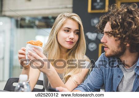 Co-workers having morning break at table View Large Photo Image Stock Image - Co-workers having morning break at table. Fotosearch