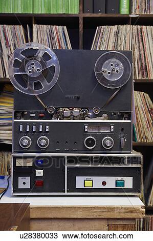 Stock Image - Collection of vinyl LP records and tape recorder. Fotosearch