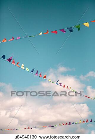 Stock Image - Colourful bunting against blue sky. Fotosearch