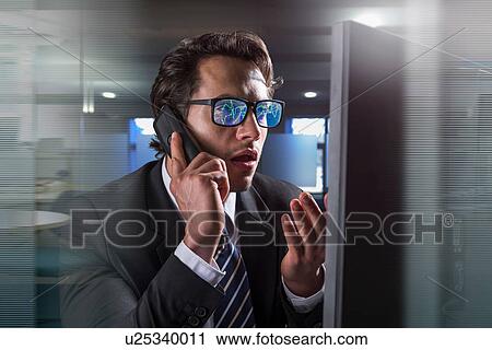 Composite image of businessman on phone at computer screen with graphical data reflected in glasses View Large Photo Image Stock Image - Composite image of businessman on phone at computer screen with graphical data reflected in glasses. Fotosearch