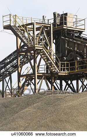 Stock Photograph - Conveyor belt over sand heap. Fotosearch