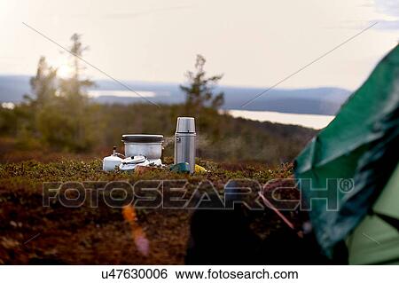 Stock Photograph - Cooking pot and coffee flask in front of tent, Keimiotunturi, Lapland, Finland. Fotosearch