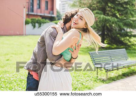 Stock Photography - Couple hugging in park. Fotosearch