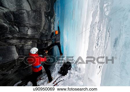Couple in cave ice climbing, Saas Fee, Switzerland View Large Photo Image Stock Photo - Couple in cave ice climbing, Saas Fee, Switzerland. Fotosearch