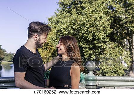 Couple on bridge face to face smiling, Berlin, Germany View Large Photo Image Stock Image - Couple on bridge face to face smiling, Berlin, Germany. Fotosearch