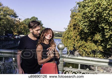 Couple on bridge hugging, smiling, Berlin, Germany View Large Photo Image Stock Photograph - Couple on bridge hugging, smiling, Berlin, Germany. Fotosearch