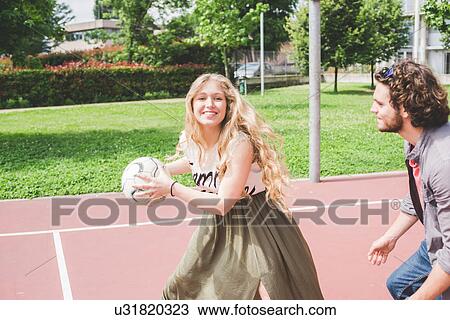 Stock Image - Couple playing basketball. Fotosearch