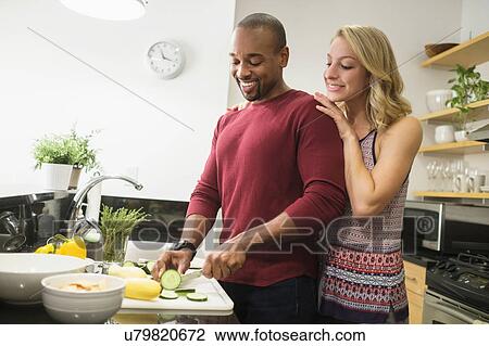 Couple preparing dinner in kitchen View Large Photo Image Stock Image - Couple preparing dinner in kitchen. Fotosearch