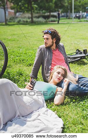 Stock Photography - Couple relaxing in park. Fotosearch