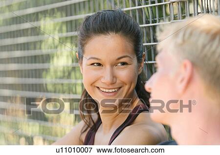 Couple talking by wire fence View Large Photo Image Stock Photo - Couple talking by wire fence. Fotosearch