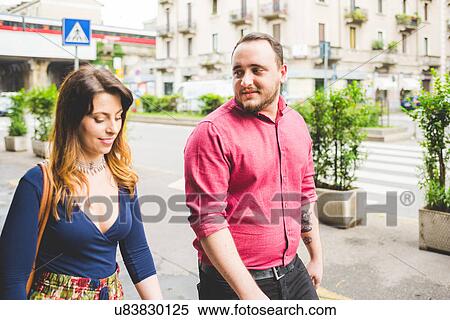 Stock Photography - Couple walking on sidewalk. Fotosearch