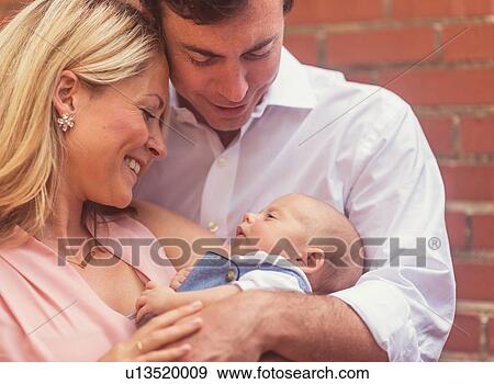 Stock Photo - Couple with baby son (0-1 months). Fotosearch