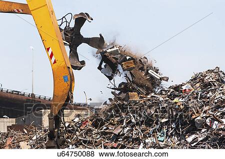 Stock Photo - Crane and heap of scrap in junkyard. Fotosearch