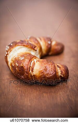Stock Photo - Croissant on wooden table. Fotosearch