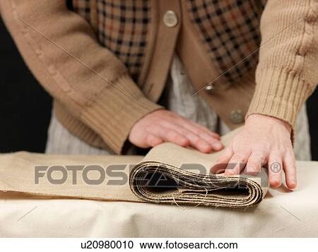 Cropped close up of young female designer's hands folding burlap fabric View Large Photo Image Stock Image - Cropped close up of young female designer's hands folding burlap fabric. Fotosearch