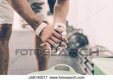 Cropped shot of male cross trainer chalking hands in gym View Large Photo Image Stock Photo - Cropped shot of male cross trainer chalking hands in gym. Fotosearch