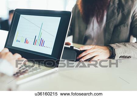 Cropped shot of young men using laptop and digital tablet at desk View Large Photo Image Stock Photography - Cropped shot of young men using laptop and digital tablet at desk. Fotosearch