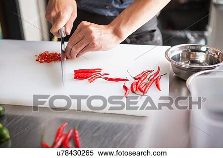 Cropped view of man slicing red chilli peppers View Large Photo Image Stock Photography - Cropped view of man slicing red chilli peppers. Fotosearch