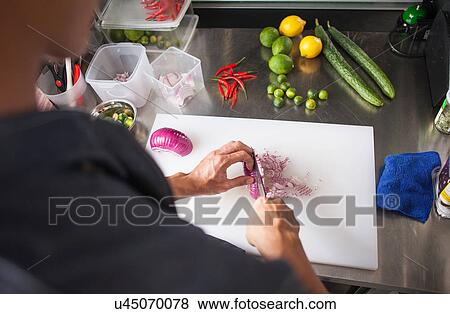Cropped view of man slicing red onion View Large Photo Image Stock Photo - Cropped view of man slicing red onion. Fotosearch