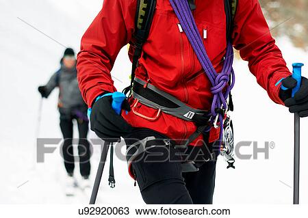 Stock Image - Cropped view of mountaineer ski touring. Fotosearch