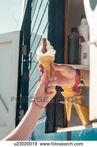 Cropped view of vendor handing customer ice cream View Large Photo Image Stock Photo - Cropped view of vendor handing customer ice cream. Fotosearch