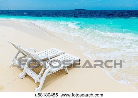 Stock Photography - Deck chairs on white sand beach, Maldives. Fotosearch