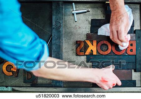 Detail of hands using letterpress machine in book arts workshop, overhead view View Large Photo Image Stock Image - Detail of hands using letterpress machine in book arts workshop, overhead view. Fotosearch