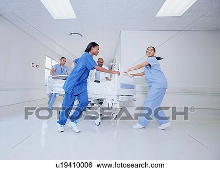 Doctor and medical running with patient bed in hospital emergency View Large Photo Image Stock Photograph - Doctor and medical running with patient bed in hospital emergency. Fotosearch