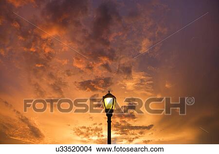 Picture - Dramatic sunset sky with lamp post in foreground. Fotosearch