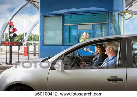 Driver in car paying at toll booth at bridge View Large Photo Image Stock Image - Driver in car paying at toll booth at bridge. Fotosearch