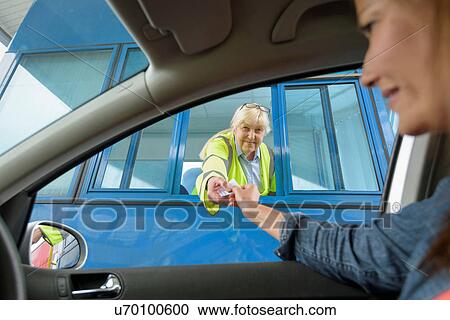 Driver in car paying toll booth at bridge View Large Photo Image Stock Image - Driver in car paying toll booth at bridge. Fotosearch