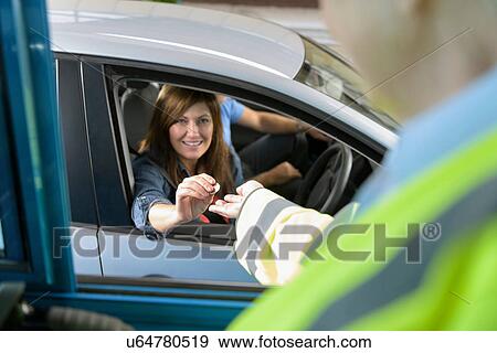 Stock Photo - Driver in car paying toll booth at bridge. Fotosearch
