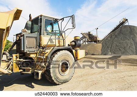 Stock Image - Dump track and heap of gravel. Fotosearch